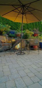pavers with umbrella and chairs