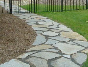 flagstone path next to mulch and grass